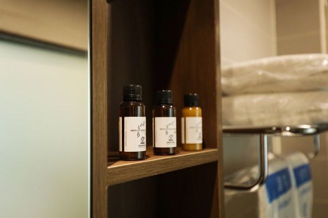 A wooden shelf with three bottles of essential oils.