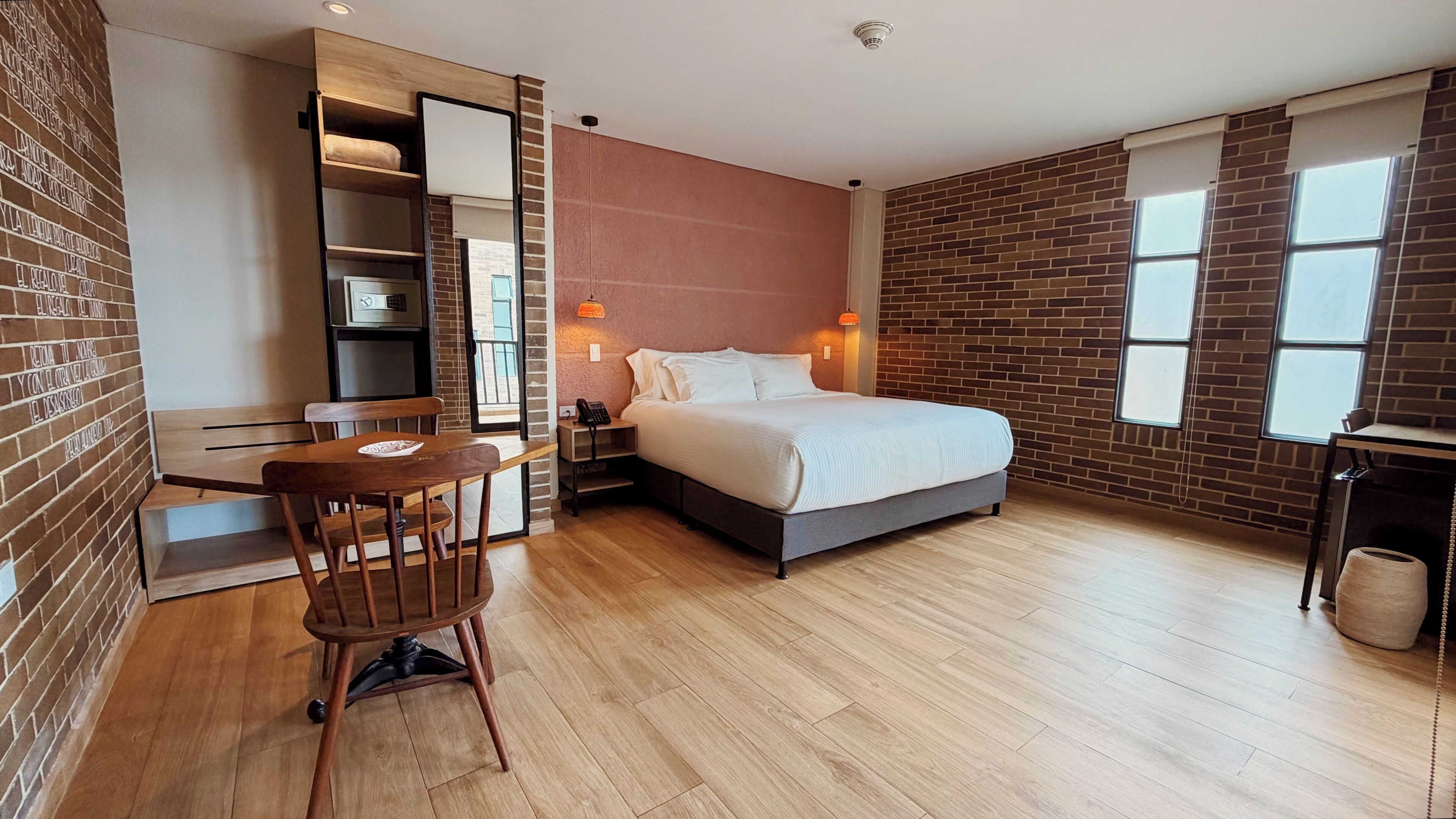 A modern bedroom with a bed, a desk, and a chair.