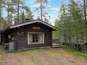 A log cabin with a sign reading 'Lakka,' a window, and a small porch area.