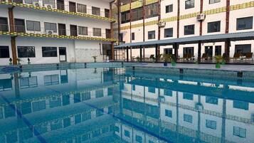 Outdoor pool, open 7:00 AM to 7:00 PM, pool umbrellas