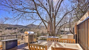 An outdoor deck with wooden furniture, a grill, and string lights. - Close to Hiking & Dtwn: Mtn-View Prescott Home! (Prescott)