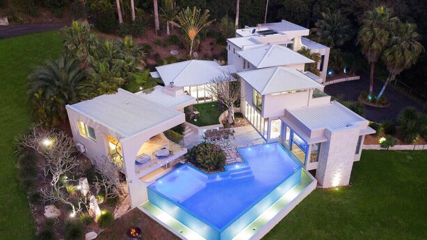 A modern house with a large swimming pool, multiple connected buildings, and well-maintained landscaping. - Colenso Luxury Home, Perfect for Friends & Family (Erina)