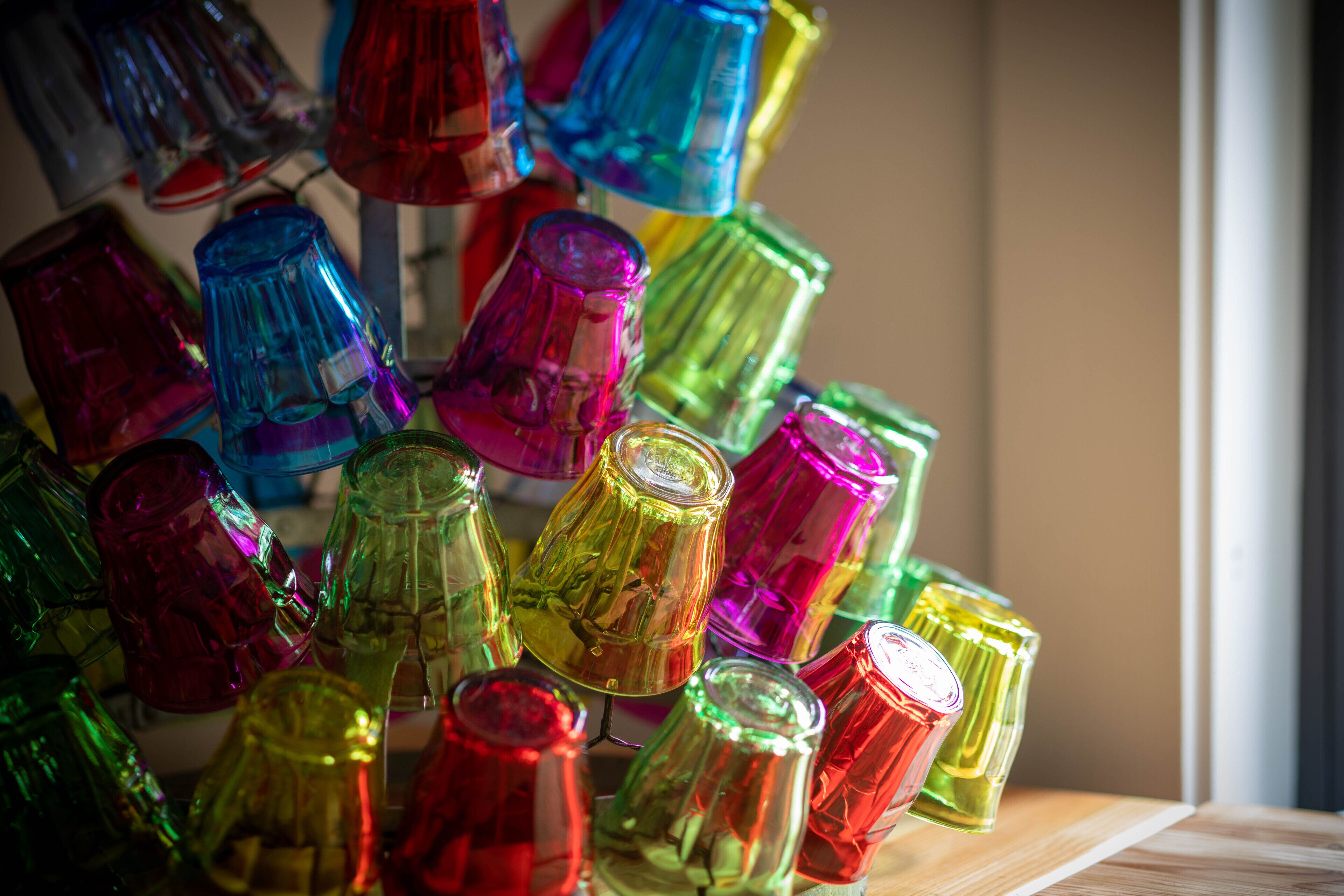 A collection of colorful glass bottles arranged on a wooden surface.