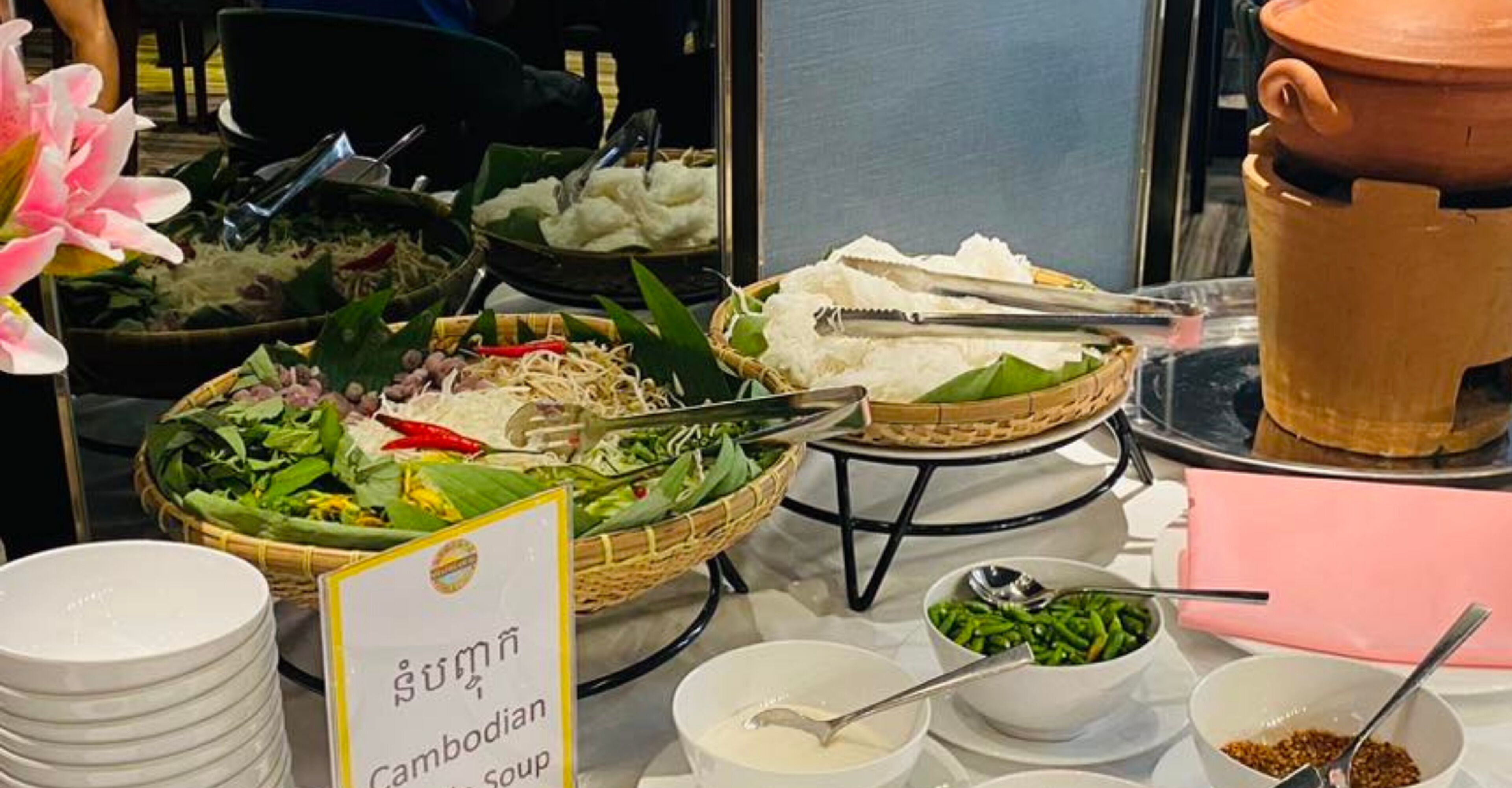 A buffet with various dishes, including rice, vegetables, and soup.