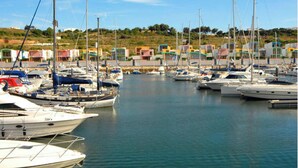 A marina with multiple boats docked, surrounded by colorful buildings. - Villa Coelho with Sea View, Pool, Garden & Wi-Fi (Albufeira)