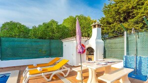 A pool area with lounge chairs, a table, and a covered seating area. - Villa Coelho with Sea View, Pool, Garden & Wi-Fi (Albufeira)