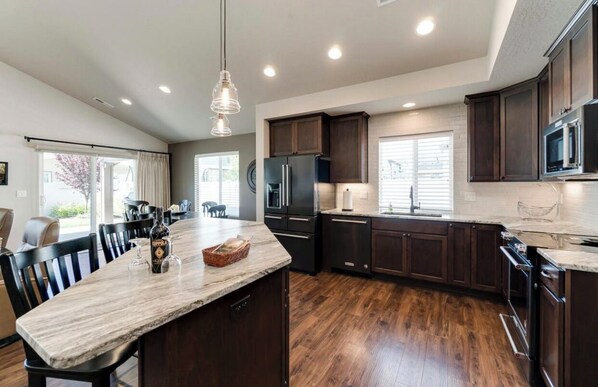 Enjoy meals in the kitchen with a central island, dining area, and large table.