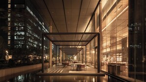 Un atrium intérieur moderne avec un plafond de verre qui reflète les lumières de la ville, et un espace central ouvert aménagé avec des sièges.