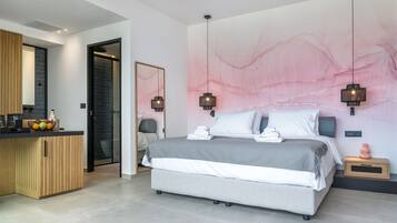 A modern bedroom with a large bed, bedside tables, and a wall-mounted artwork.