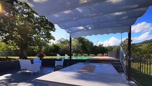 An outdoor patio with a table and chairs, a pool, and a view of the surrounding greenery. - Rosalba, Private solar heated pool, walk restaurants, romantic, mountain views.  (Corfino)