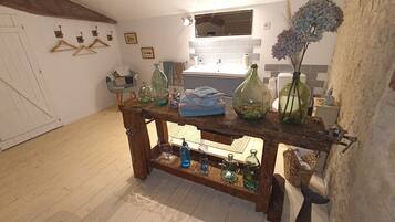 Une table en bois rustique, avec des bouteilles en verre et une serviette bleue.