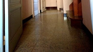 A hallway with a wooden ceiling, a door on the left, and a staircase on the right. - Country house 5 min from lake genin (Charix)