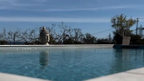 A clear pool with a statue in the background. - Superb T3 N°1 Garden level Apartment, swimming pool, terrace (bastia)