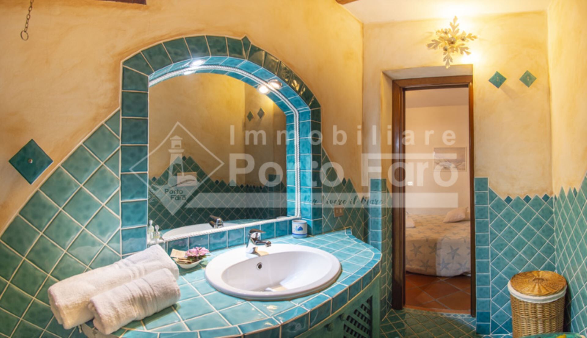 A bathroom with a large mirror, a sink, and a shower area.