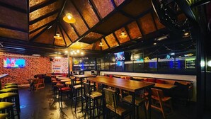 A restaurant with brick walls, wooden tables, and hanging lights. - The Pera Hotel Marmaris (Marmaris)