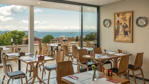 A restaurant with a terrace overlooking a scenic view.