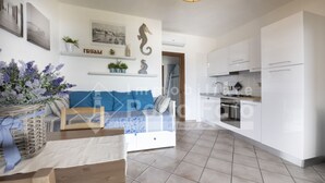 A modern kitchen with white cabinets and a built-in oven. - L304 Appartamento - L304 PORTO MANNU (Palau)