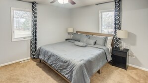 A bedroom with a bed, two bedside tables, a ceiling fan, and a window with a curtain. - Belleville Beauty - Luxury Stay For Work Or Stay For Play Either Way This Is The Perfect Property For You! 4 Bedroom Residence by RedAwning (Belleville)
