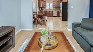 A modern kitchen with wooden cabinets, a refrigerator, and a dining area with a bench and table. - Belleville Beauty - Luxury Stay For Work Or Stay For Play Either Way This Is The Perfect Property For You! 4 Bedroom Residence by RedAwning (Belleville)