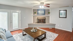 A living room with a fireplace, a ceiling fan, and a sofa. - Belleville Beauty - Luxury Stay For Work Or Stay For Play Either Way This Is The Perfect Property For You! 4 Bedroom Residence by RedAwning (Belleville)