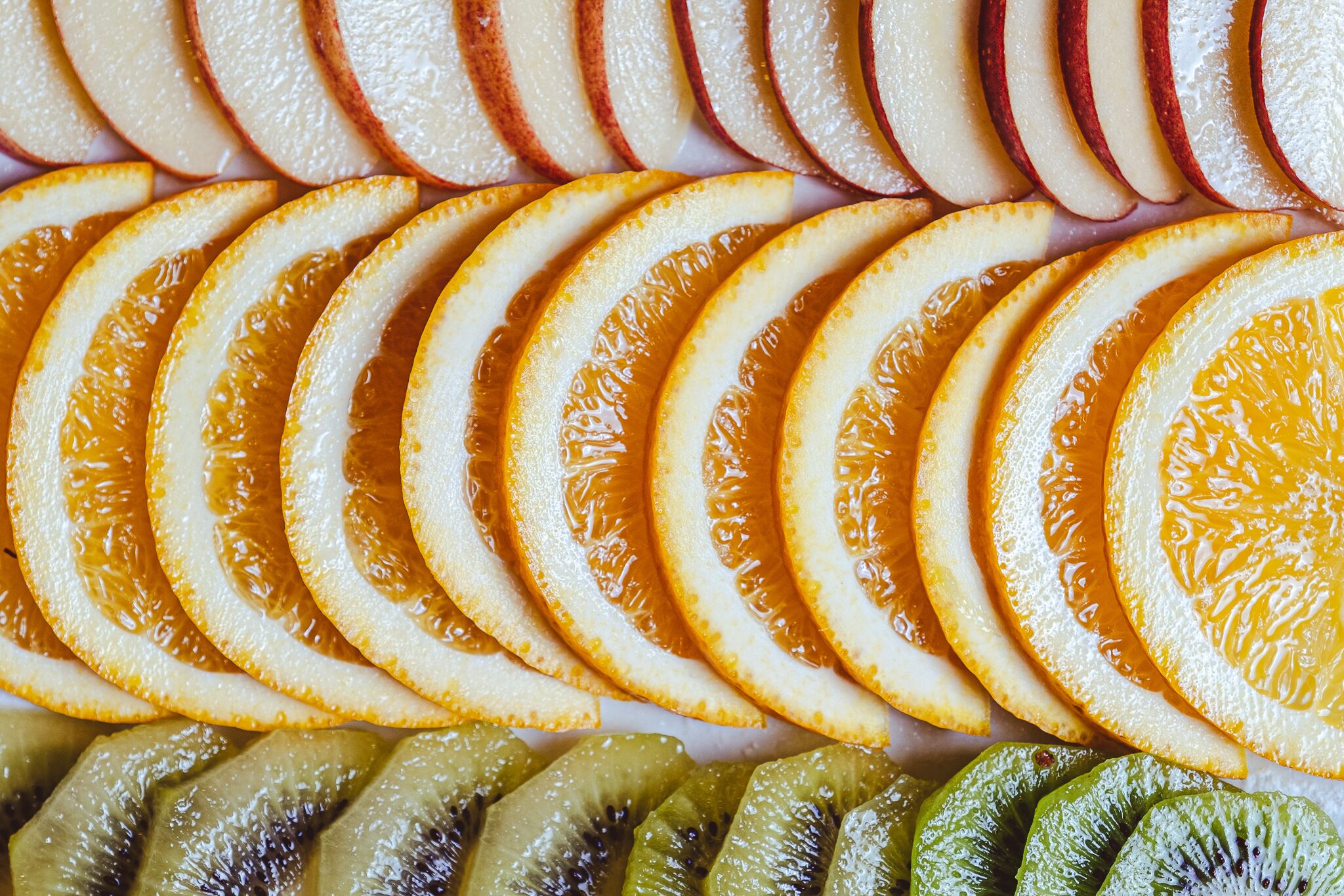 A variety of sliced fruits arranged in a circular pattern.
