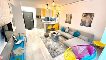 Standard Apartment | Living area | 110-inch flat-screen TV with cable channels