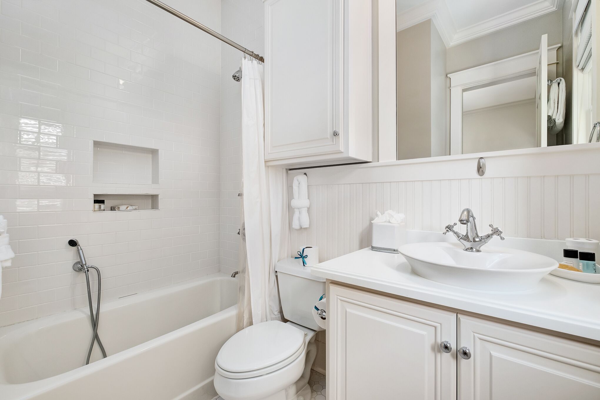A modern bathroom with a bathtub, toilet, and sink.