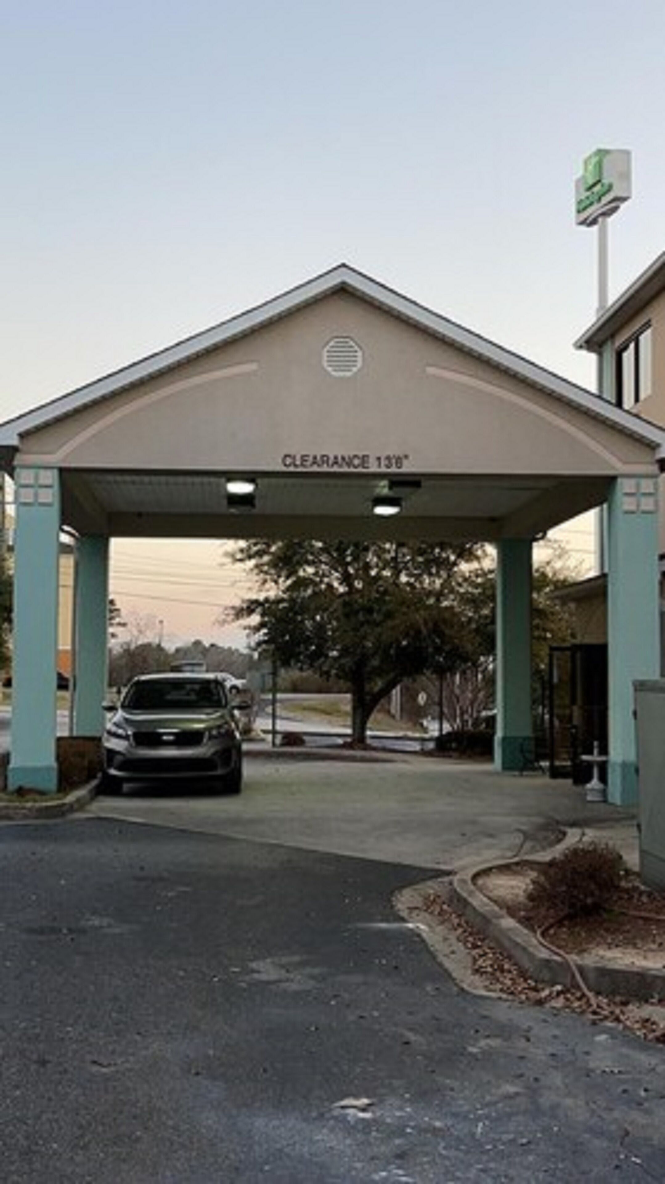 A building entrance with a sign indicating a clearance height of 13'0".