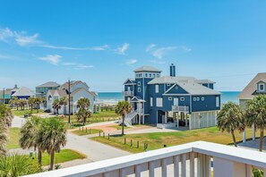 A coastal residential area with houses, a clear sky, and a view of the ocean. - 2nd Row Gulf views, 2 decks, Updated Private Beach House (Galveston)