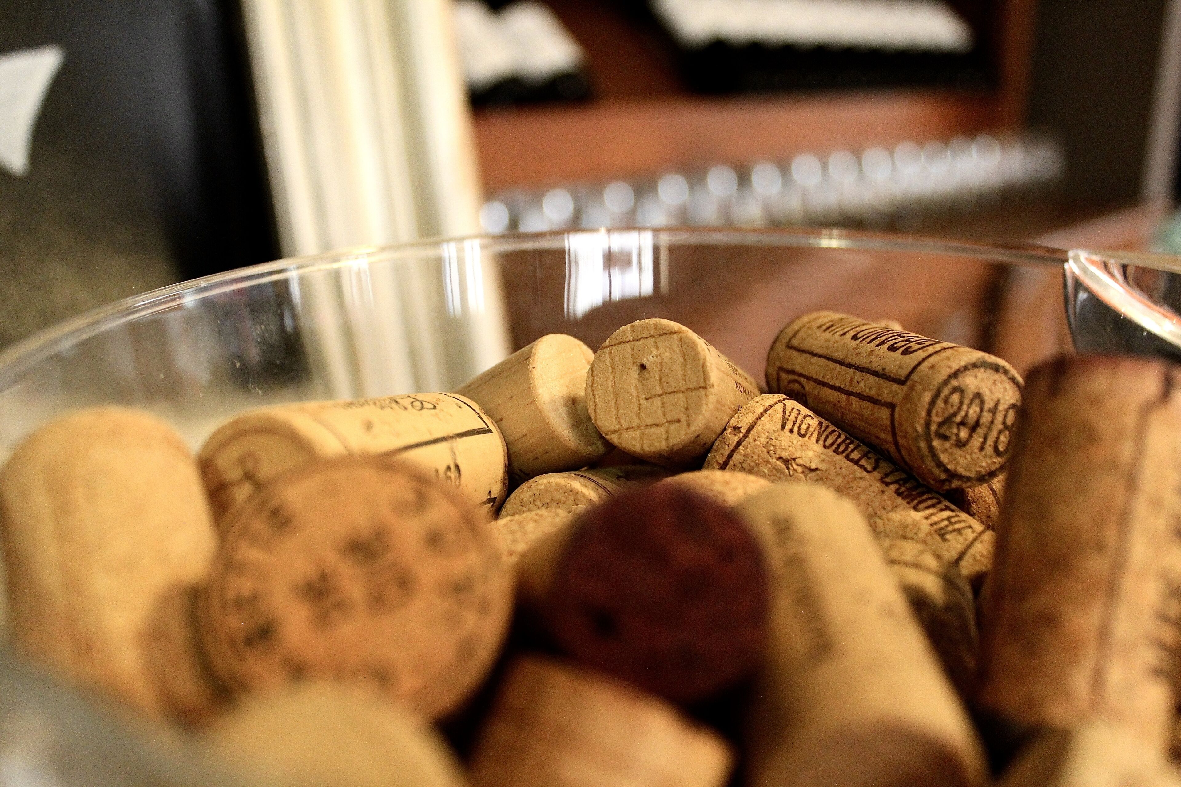 A glass bowl filled with wine corks.