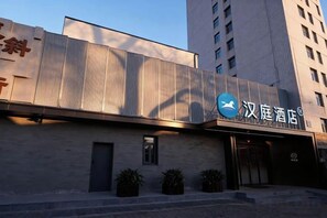 A hotel with a modern facade, a prominent logo, and a flat roof. - HanTing Hotel (Beijing Xidan Mall) (Beijing)