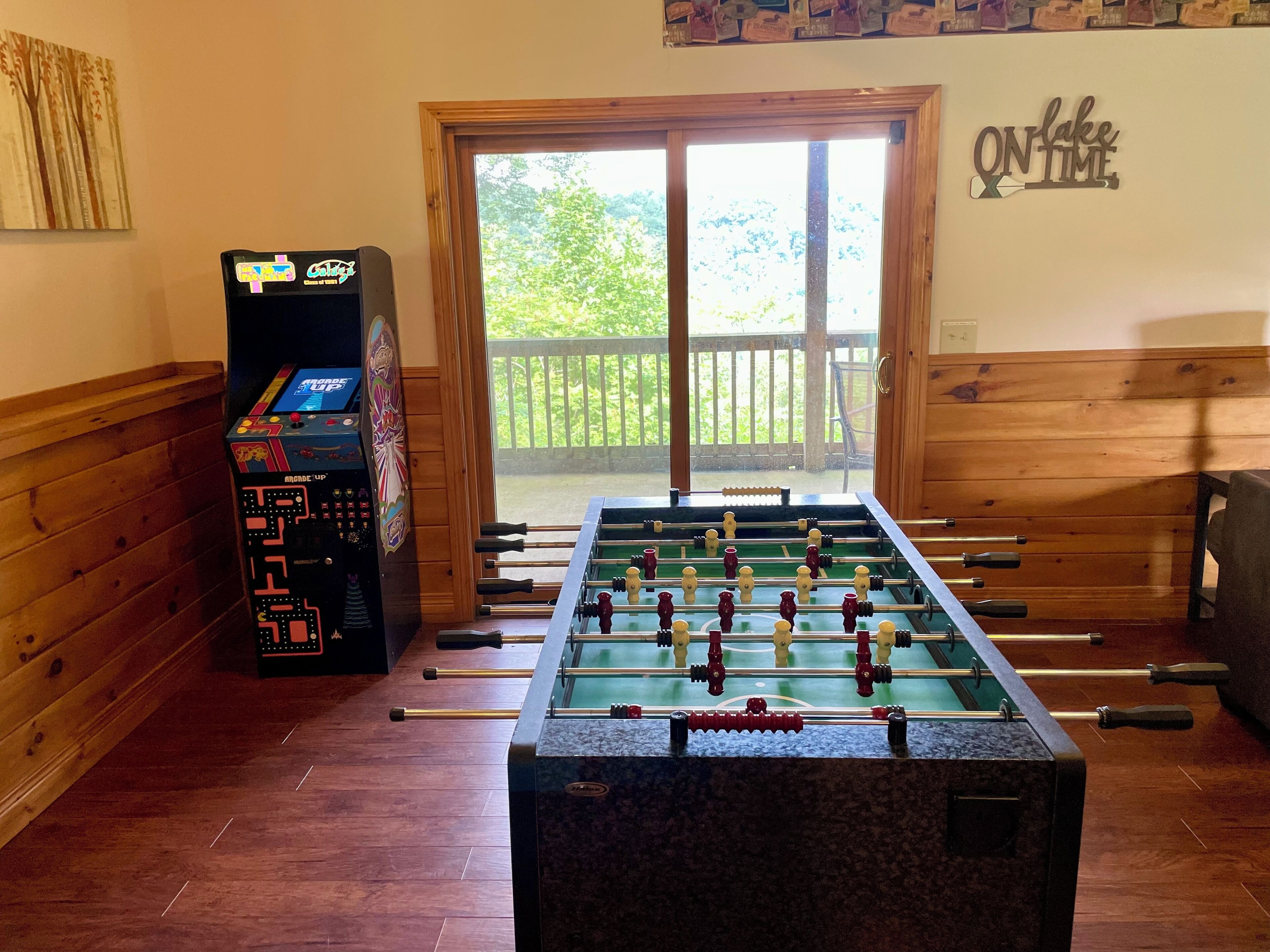 A foosball table with a wooden backdrop and a foosball table with a wooden backdrop.