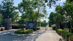 A gated entrance with a sign reading "Stillwater at Life Estates." - Beautiful secluded cabin - sleeps 12, fire pit, fishing pond, grill, game room (russell springs)