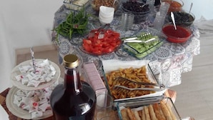 A buffet table with various food items, including fruits, vegetables, and condiments. - Liya Pansiyon (Ezine)