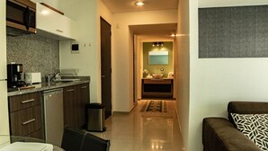 A modern kitchen with granite countertops, a coffee machine, and a trash can. - Tiny Apartment with Rooftop pool y GYM (Mexico City)