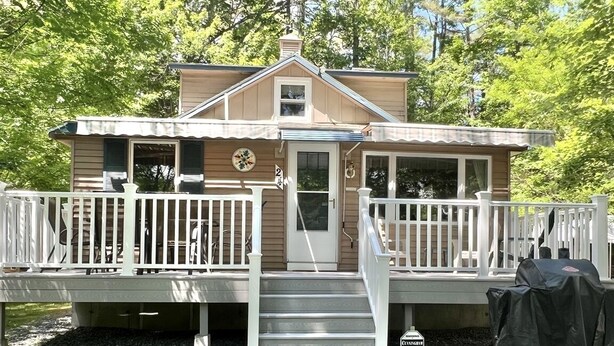 A two-story house with a porch, a covered grill, and a mailbox. - Great Place for a Family Retreat! Sleeps 10 (Naples)