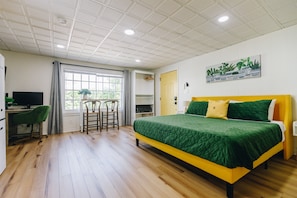 Un dormitorio con una cama, un escritorio y una silla.