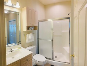 Bathtub, hair dryer, towels, shampoo