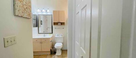 Bathtub, hair dryer, towels, shampoo
