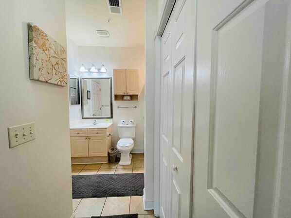 Bathtub, hair dryer, towels, shampoo