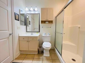 Bathtub, hair dryer, towels, shampoo