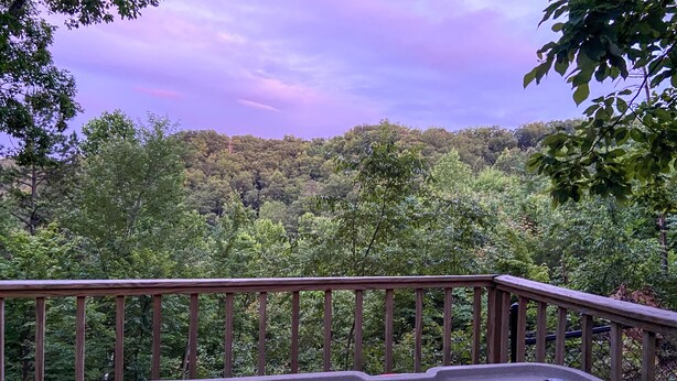 A hot tub with a wooden deck and a forest view. - MTN View Cottage Getaway Stunning Fall Colors Private Bathroom per bedroom (Sevierville)