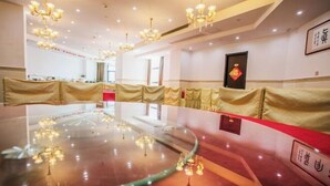 A conference room with a large glass table, red carpet, and golden drapes. - Zhongpu Hotel (Shangrao)