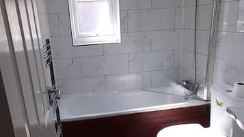 Bathtub, hair dryer, towels, soap