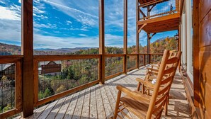 A wooden deck with a view of a mountainous landscape. - Beautiful Mt. View Pool Cabin with Hot Tub & Arcade Games! Perfect for Families! (Sevierville)