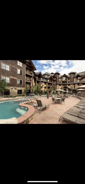 Guests can enjoy a relaxing pool area with lounge chairs and umbrellas.
