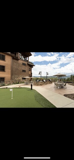 Relax in a serene outdoor space with a beautifully manicured lawn, walkway, and seating area.