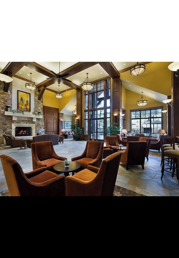 Relax in the inviting lobby with a fireplace, comfortable seating, and large windows.