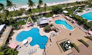 A resort with multiple swimming pools, sun loungers, and a beach area. - Stylish Modern 3 Bedroom Miami Beach - 611 (Miami Beach)