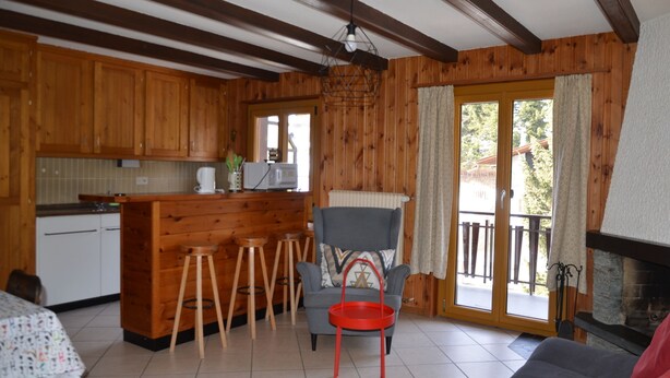 A wooden interior with a kitchen, bar area, and seating. - flat for rent in Les Collons (Thyon-Les Collons)